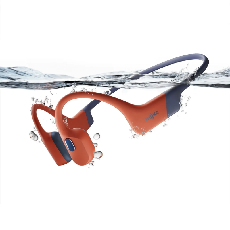 Shokz OpenSwim Pro in orange and blue, partially submerged in water