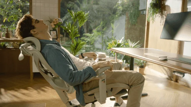 Man relaxing in COFO Chair Pro 2, showing headrest