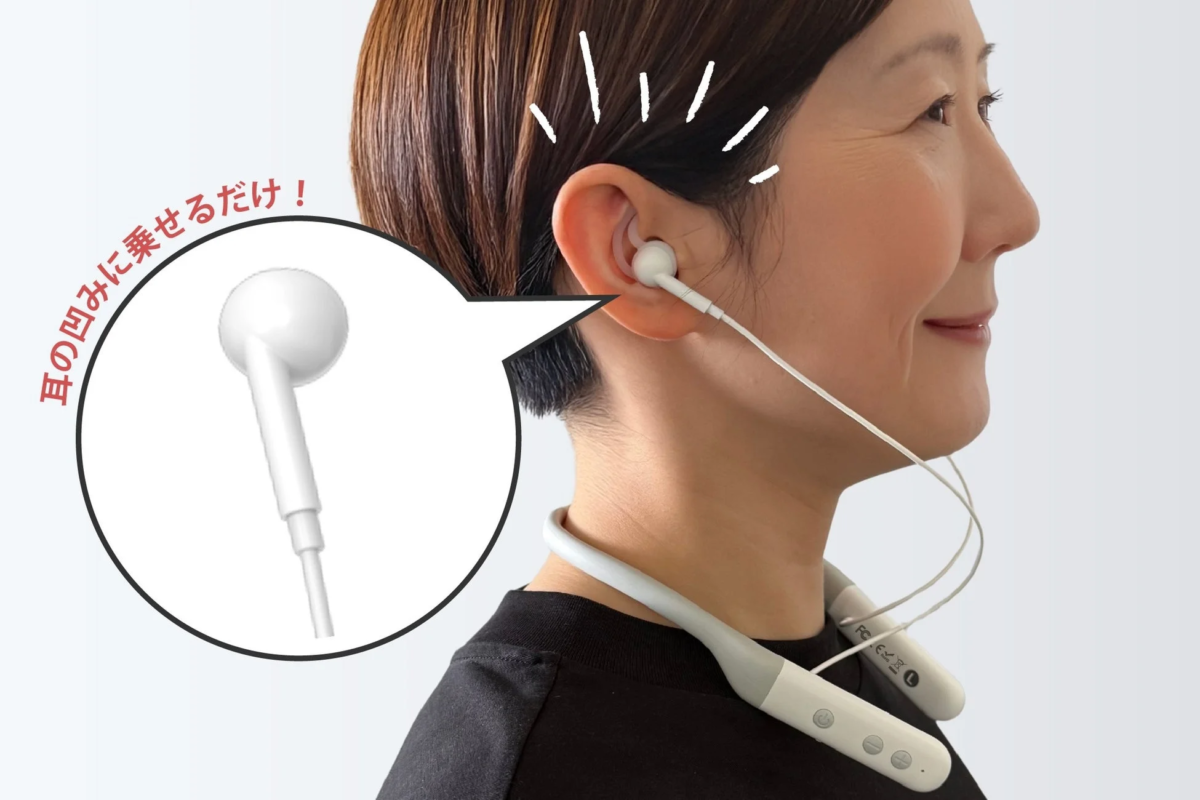 Woman placing earphone in ear hollow