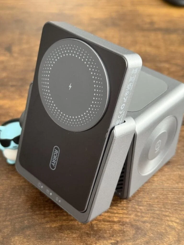 Black and gray wireless charger on a wooden table