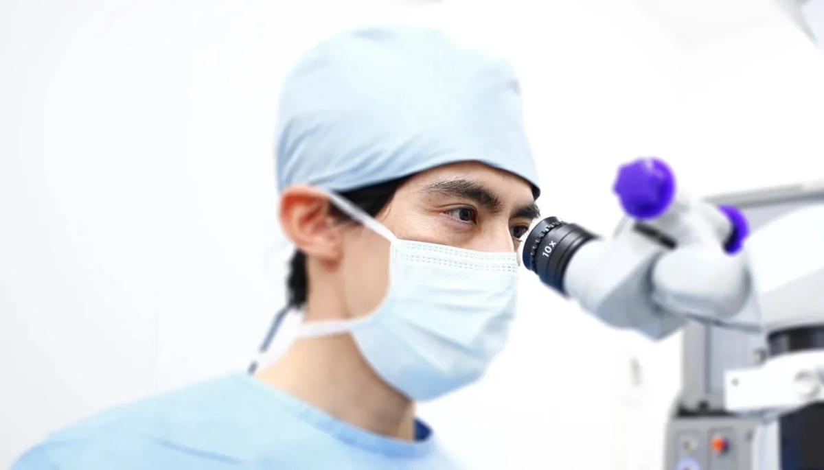 Medical professional using a microscope