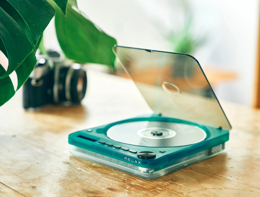 Emerald green portable CD player on a wooden table