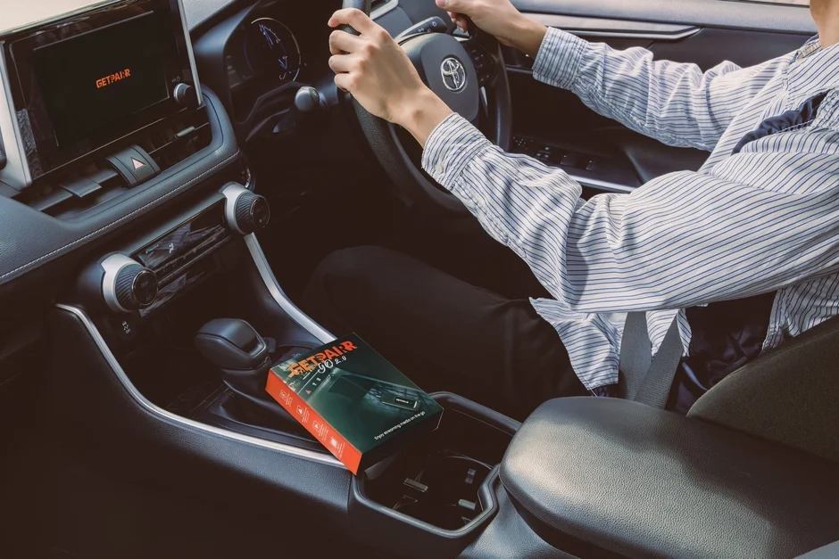 Person driving, product box visible