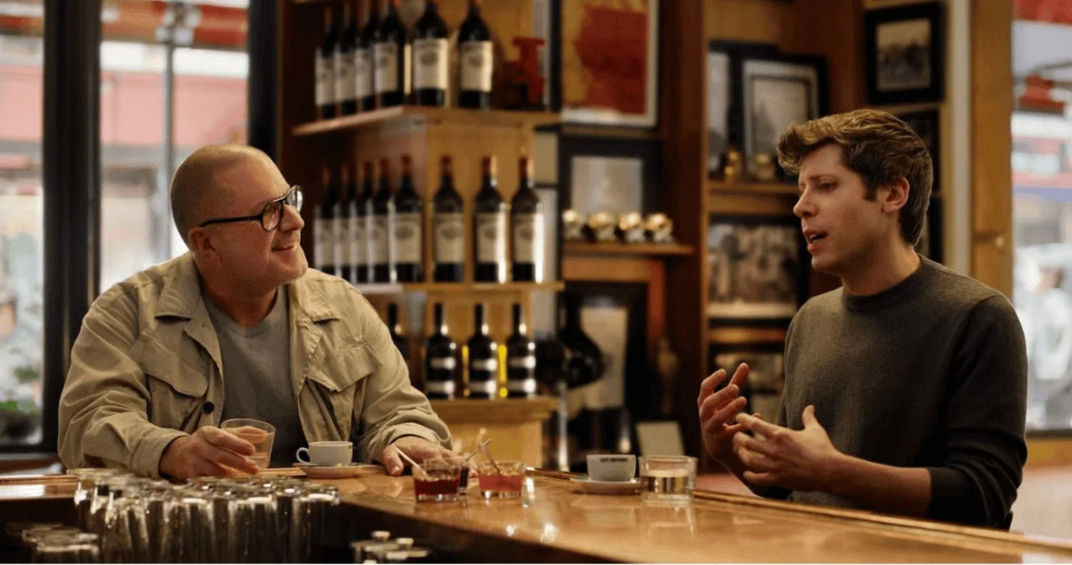 Two men conversing at a bar