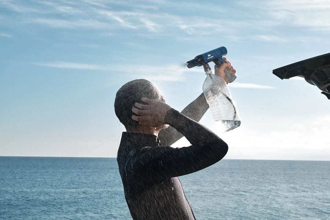 Person showering with wetsuit