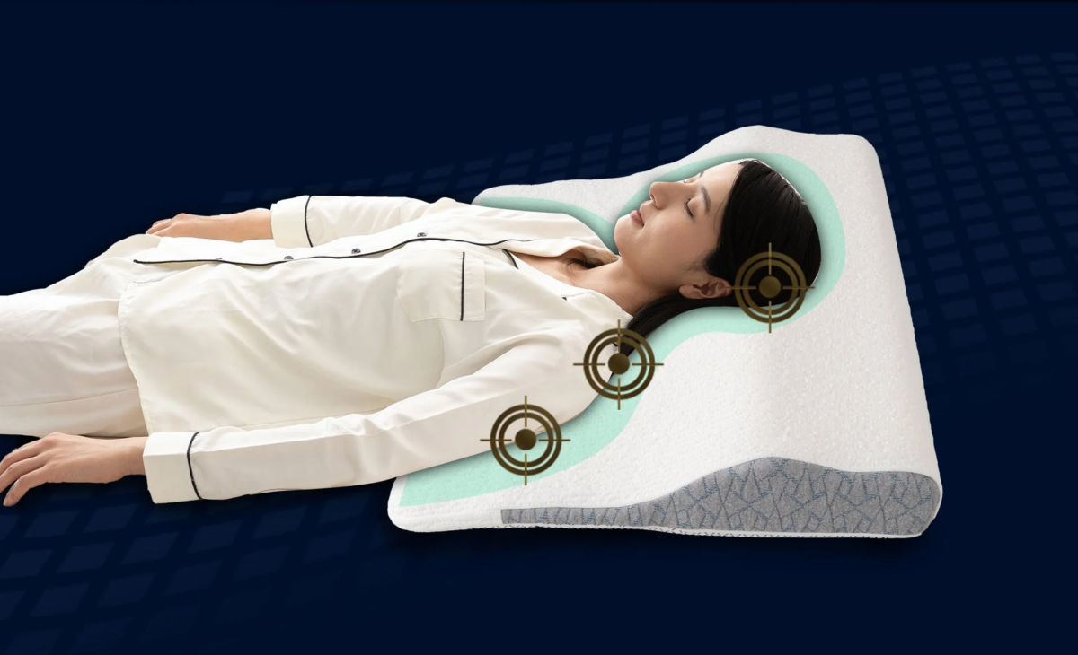 A woman sleeping on her back, supported by an ergonomically designed pillow that cradles her head, neck, and shoulders.