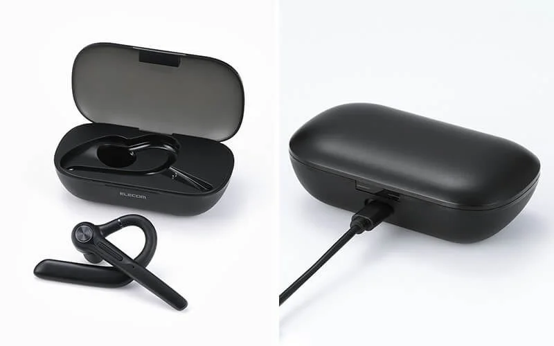 Black wireless headset and its charging case, shown open and charging via a USB cable