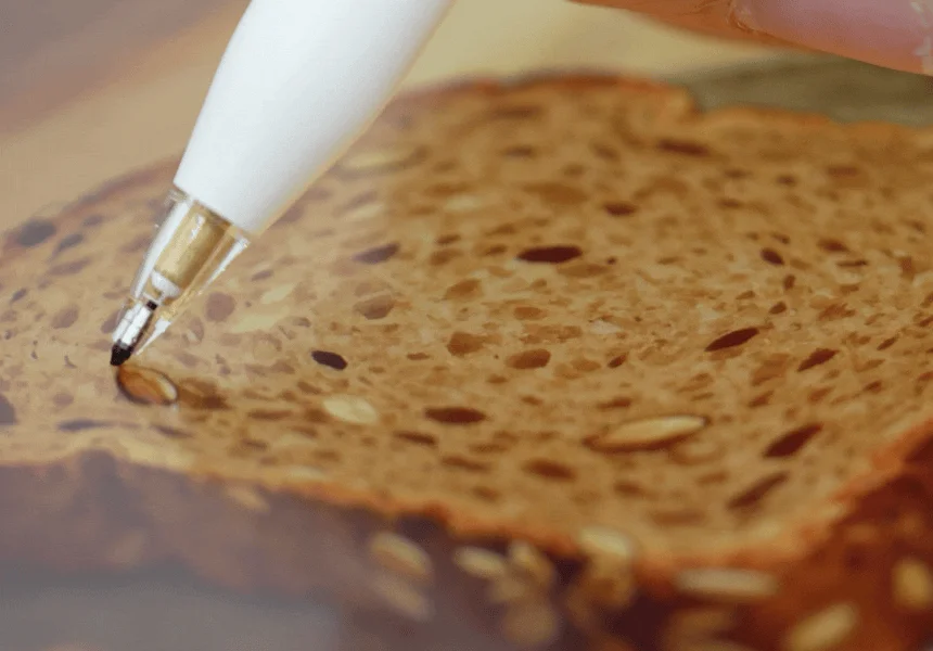 Pen tip touching bread, illustrating new tactile sensation