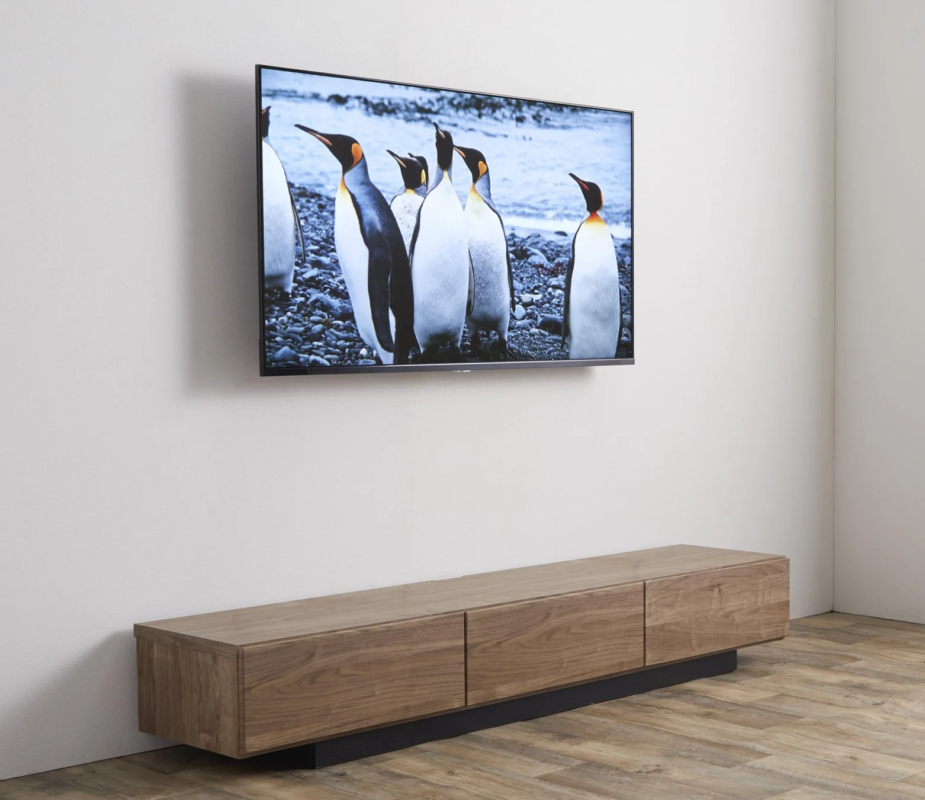 TV in a modern living room showing penguins on a beach, viewed from an angle