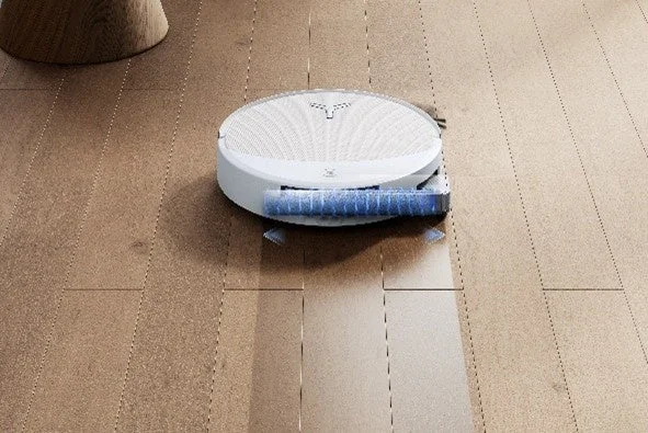 Robot vacuum cleaner cleaning a wooden floor