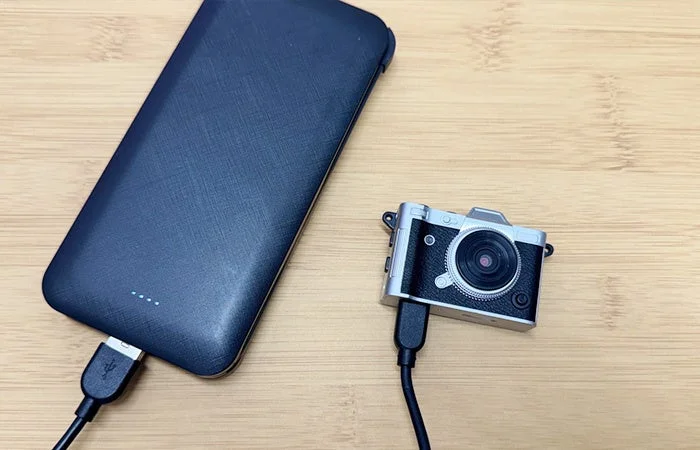 Mini camera being charged by a power bank