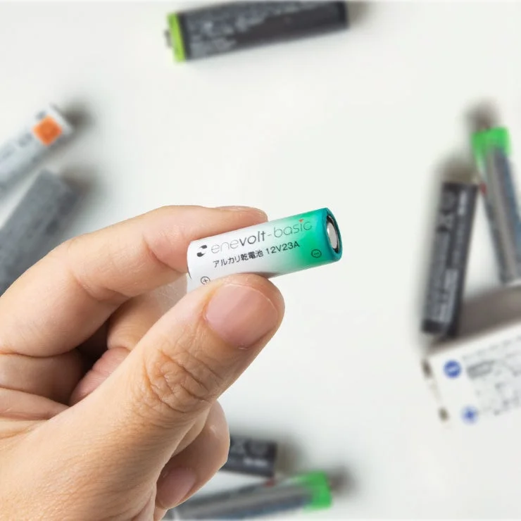 Hand holding Enevolt Basic 12V23A Alkaline Battery