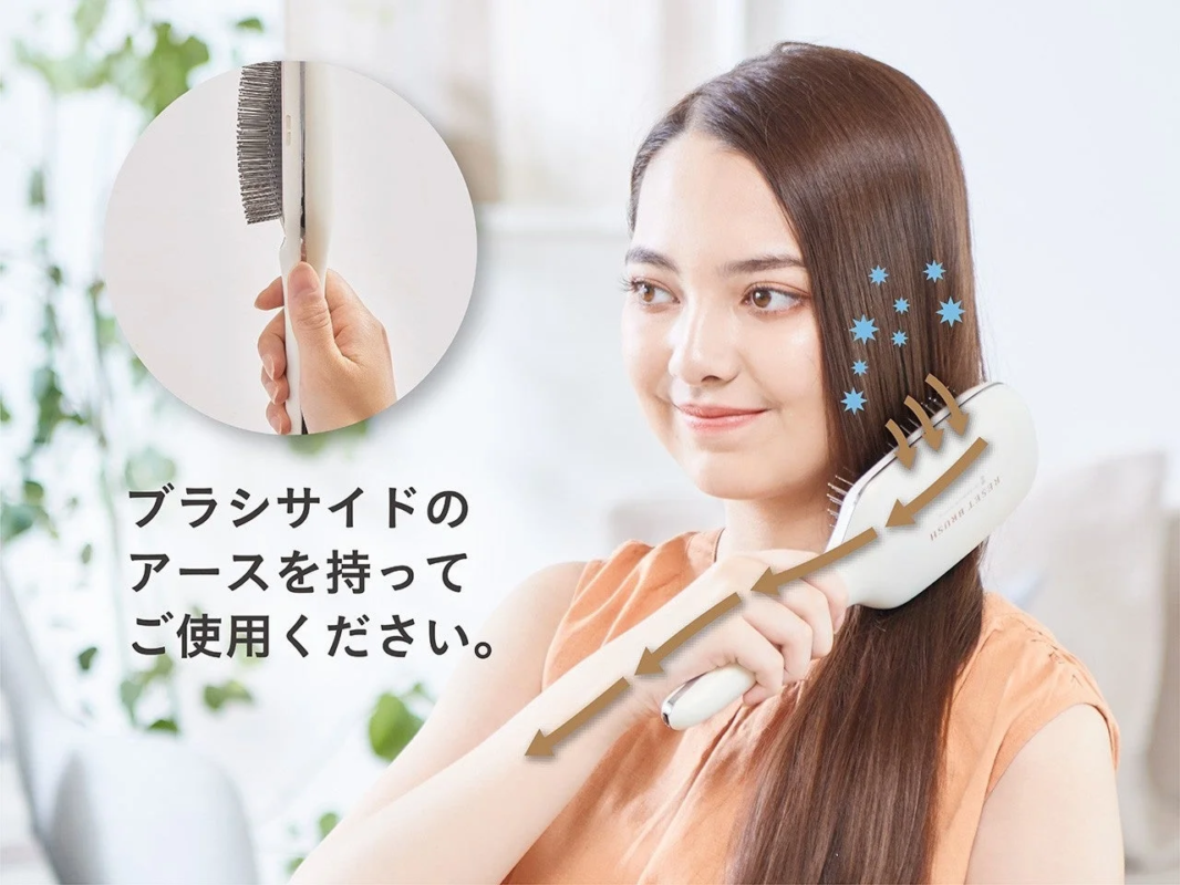 Woman brushing hair with Reset Brush