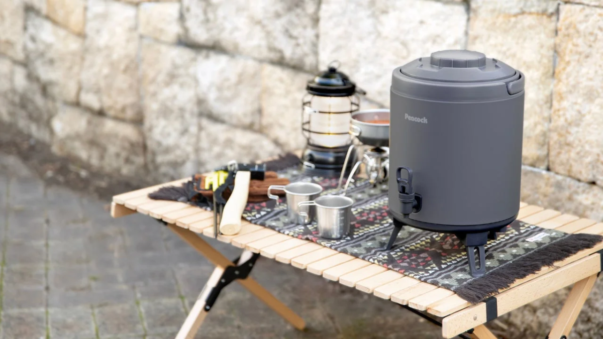 Camping scene with a gray water jug on a wooden table