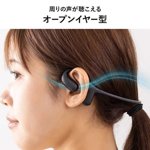 Woman wearing open-ear earphones