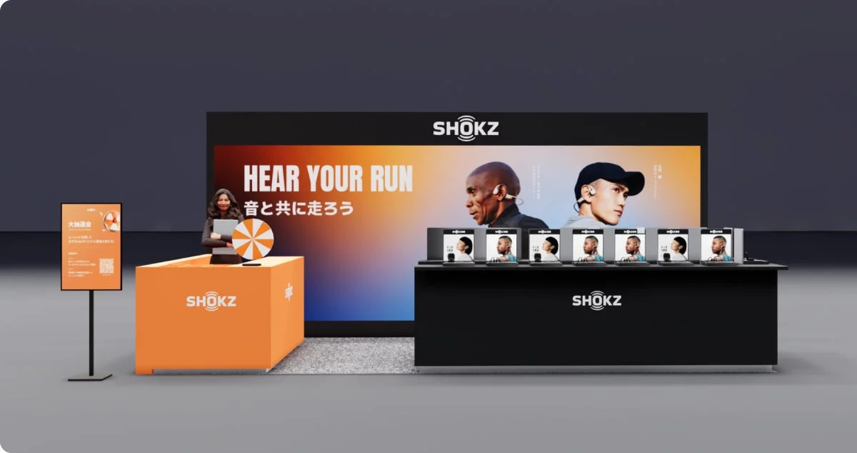 SHOKZ event booth with "HEAR YOUR RUN" slogan and staff
