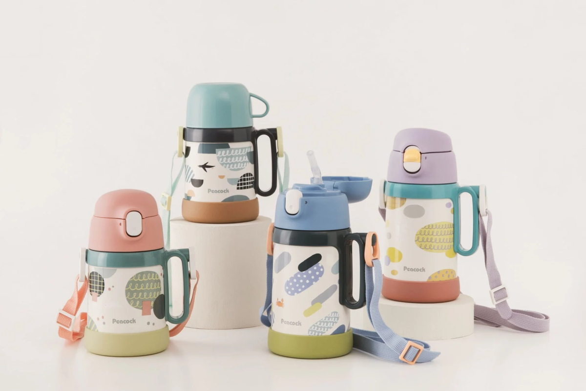 Four colorful kids' water bottles with different caps