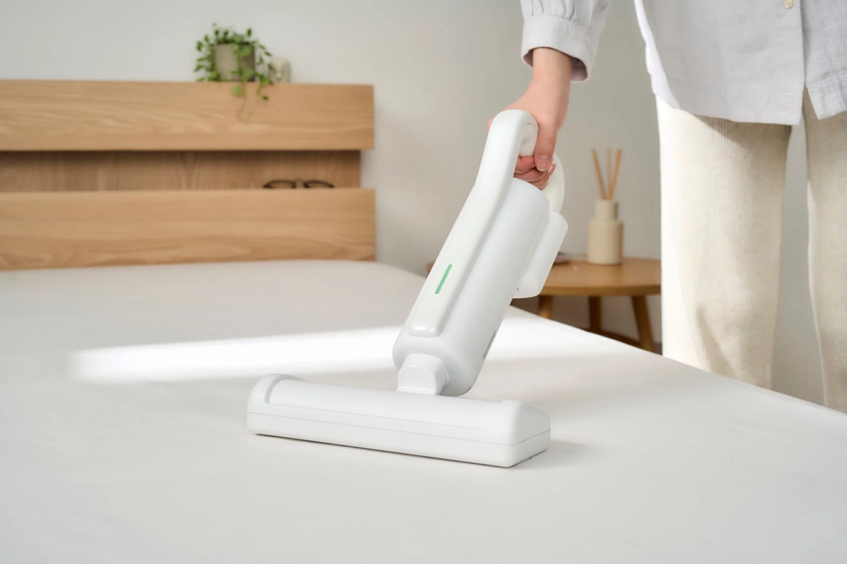 Futon cleaner in action on a bed