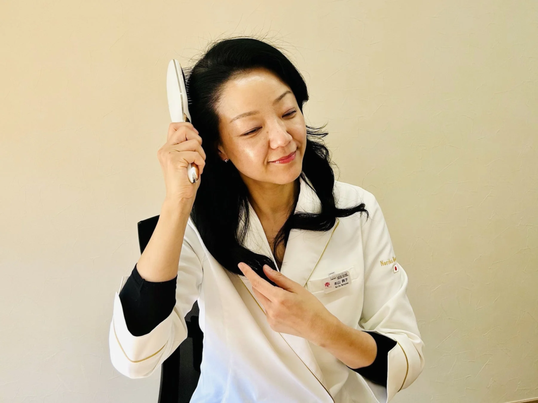 Woman brushing hair with white uniform