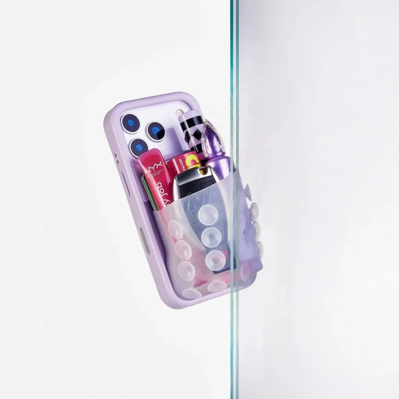 Purple iPhone case attached to glass partition with cosmetics