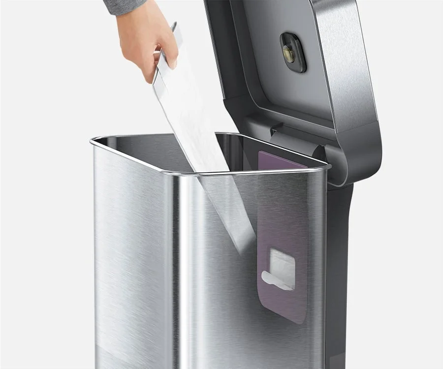 Hand installing a trash bag into the sensor can