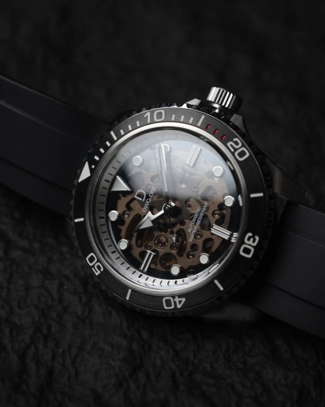 Close-up of an automatic skeleton diver's watch with a black rubber strap, showcasing its intricate internal mechanism