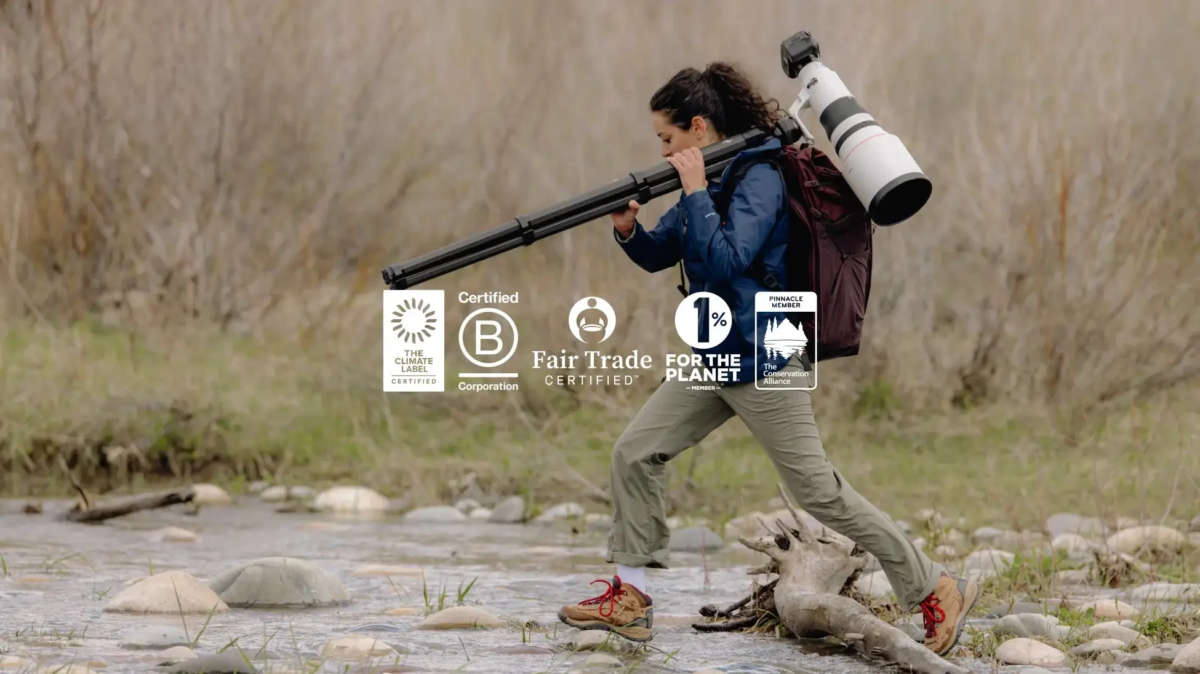 Woman with camera gear and sustainability logos