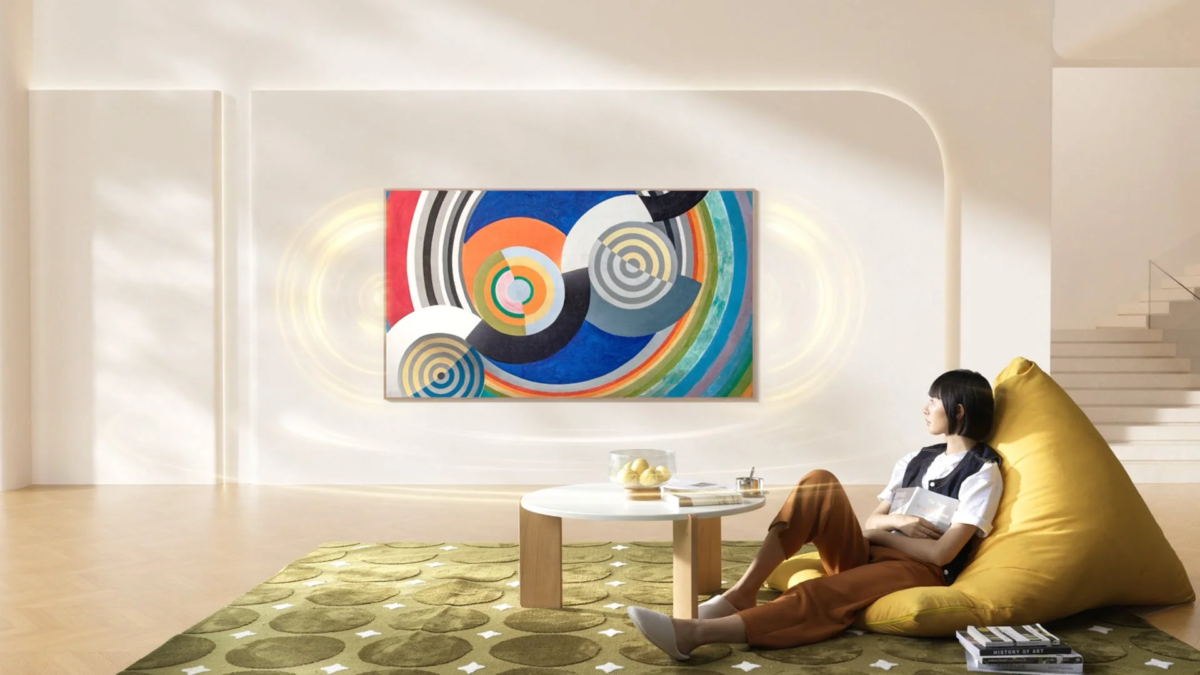 Woman relaxing in living room with art on large screen