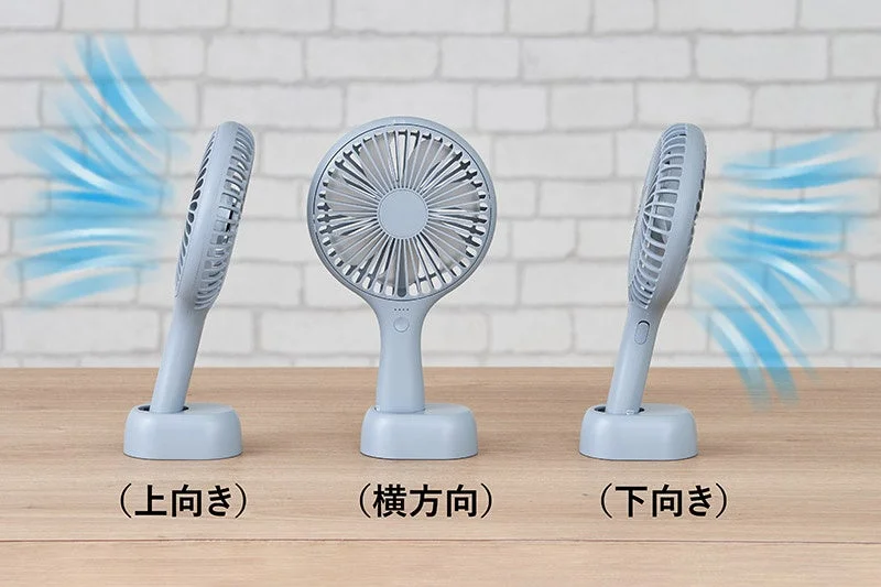 The Uchiwa Handy Fan shown in three different orientations on its stand: facing up, sideways, and down