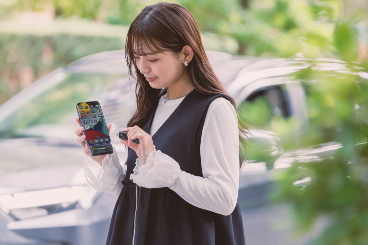 Woman holding GetPairr device