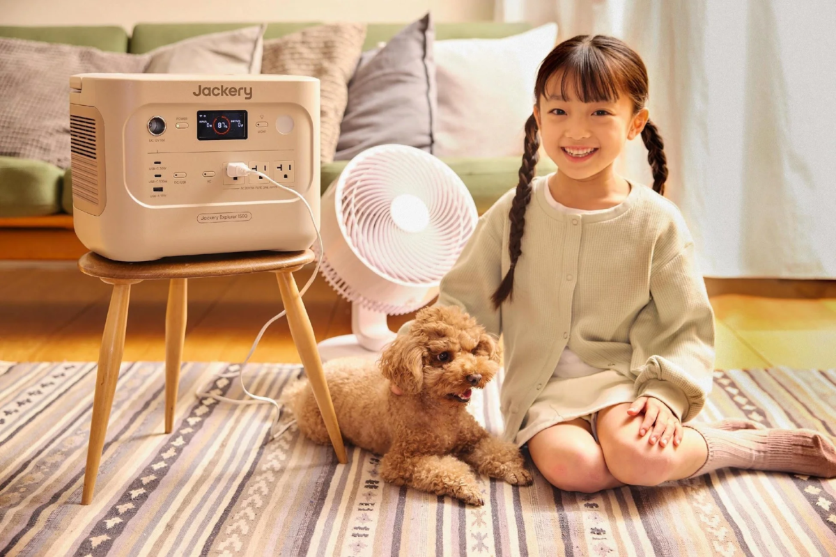 Girl and dog relaxing with Jackery power station and fan