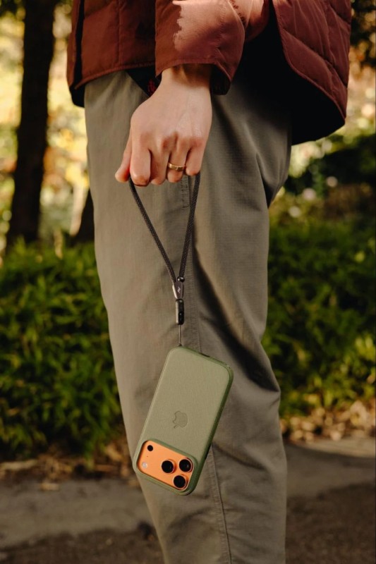 Man wearing an iPhone on a wrist strap