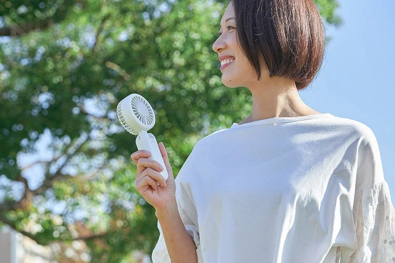 Woman smiling with fan