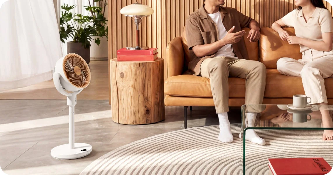Couple relaxing in a modern living room with a white fan