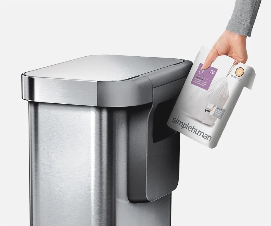 Hand pulling a trash bag from the internal liner pocket