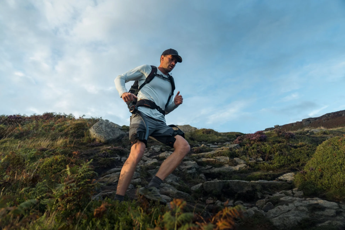 Man climbing a mountain with Hypershell X Ultra