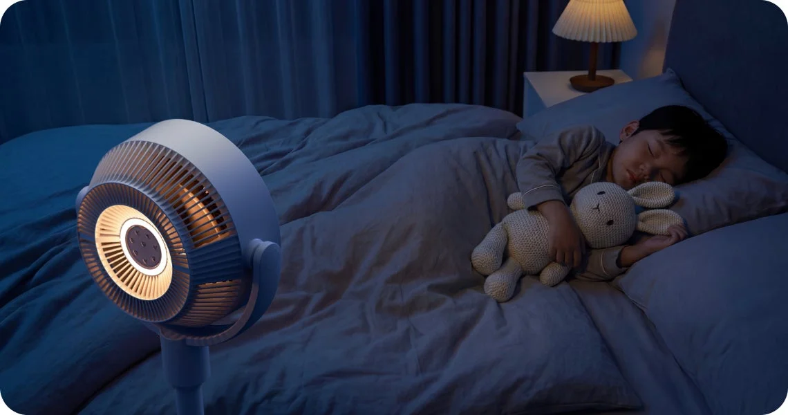 Child sleeping in a bedroom with a fan and night light