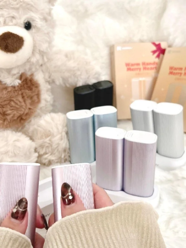 Hand holding RORRY hand warmer, with plush toy