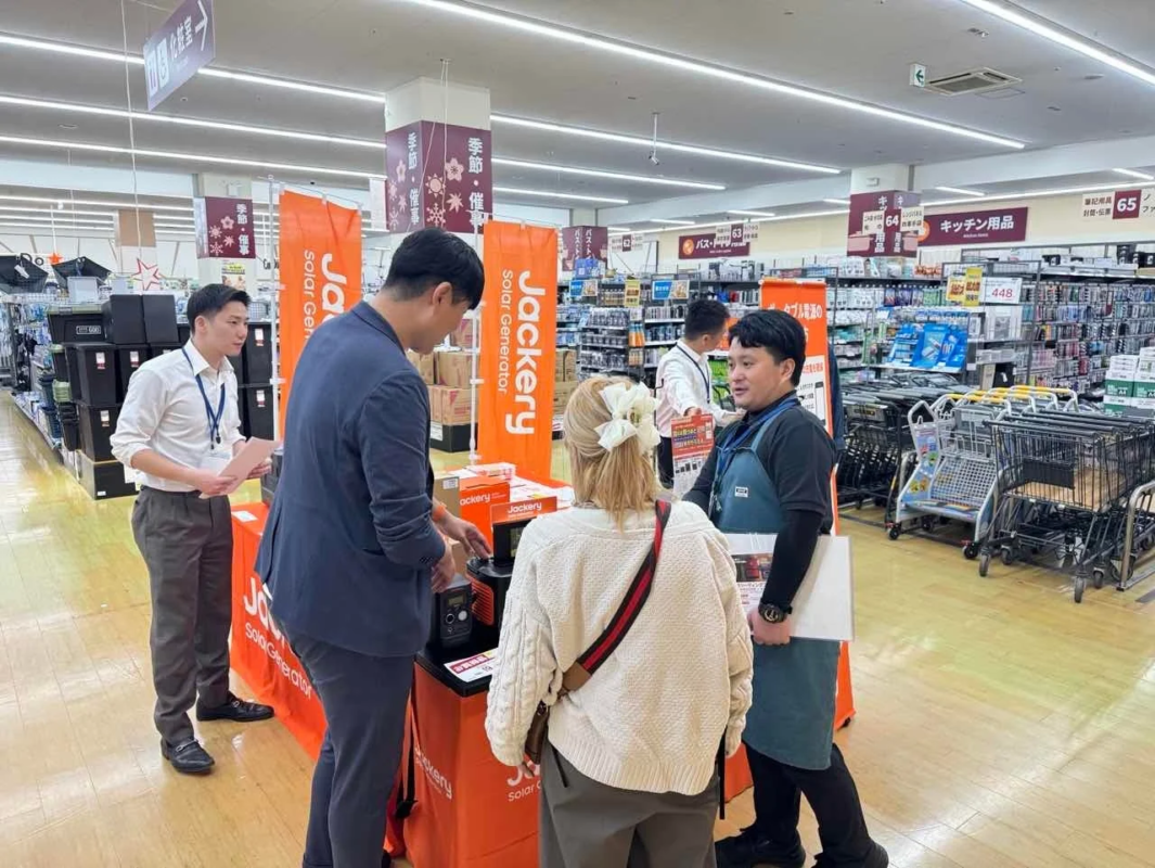 Staff explaining Jackery products in a store