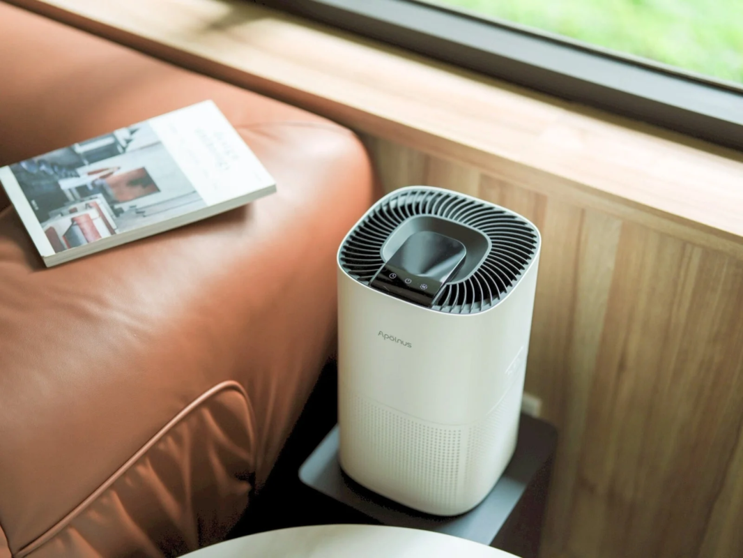 Air purifier next to a sofa in a living room
