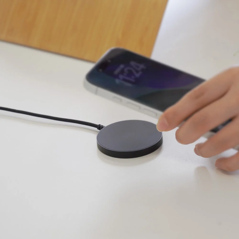Wireless charger on desk with phone