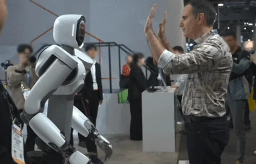 Humanoid robot ALLEX interacting with a man at an exhibition