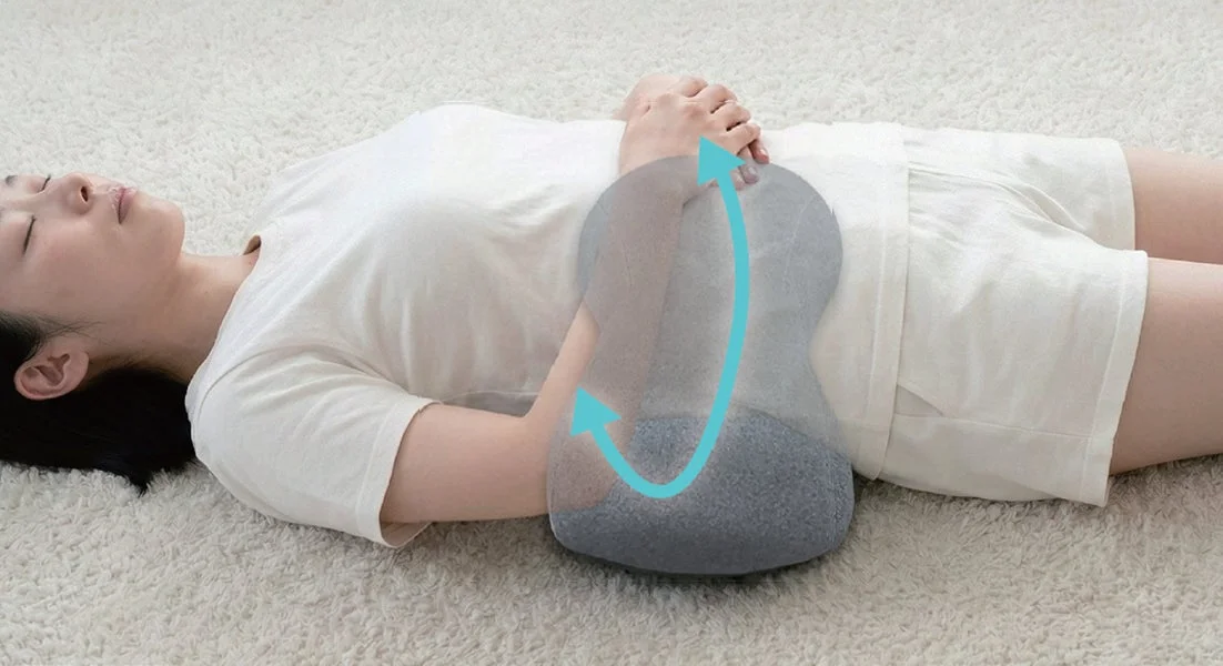Person stretching with cushion, side view