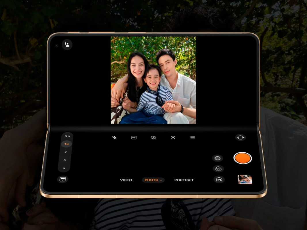 Foldable smartphone displaying a family photo in camera app interface