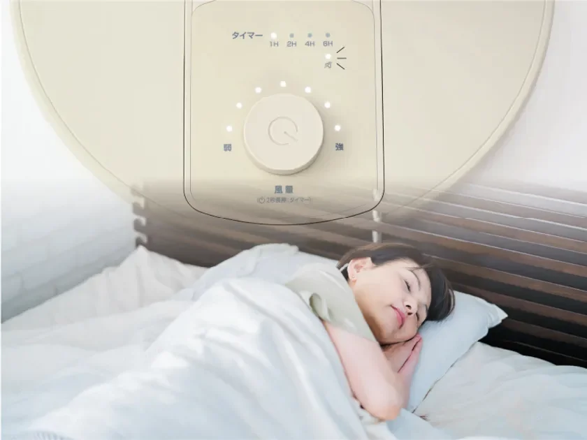 Woman sleeping peacefully with a fan nearby, highlighting the silent function