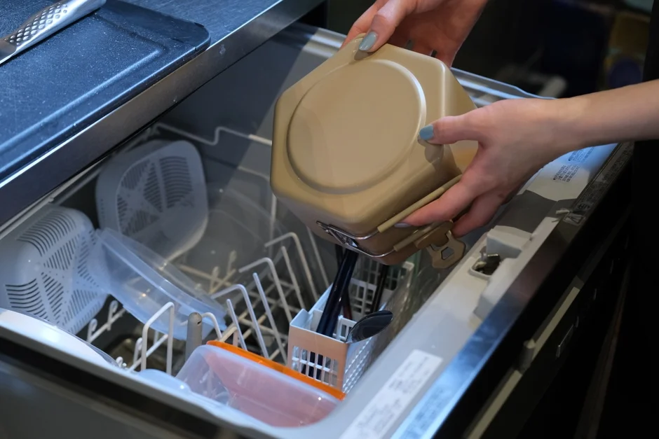 Dishes being loaded into a dishwasher