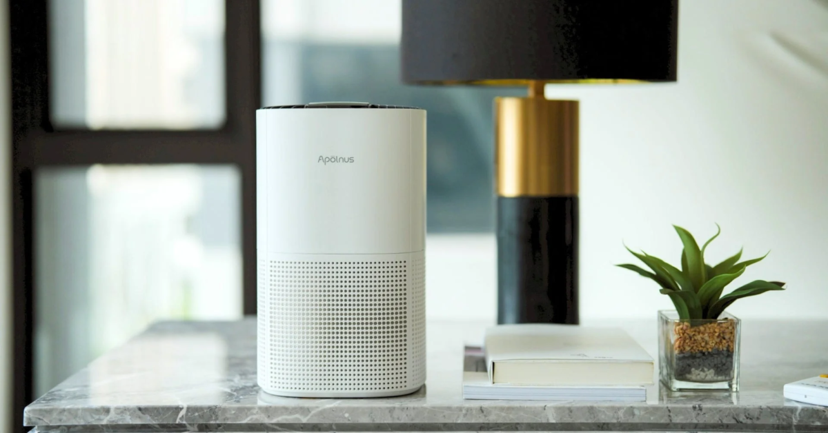 Air purifier on a marble table with plants
