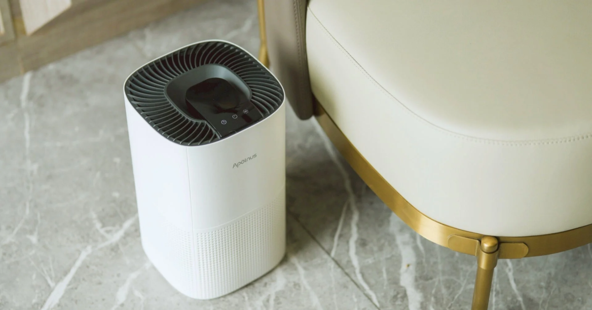 Air purifier in a modern room with a chair