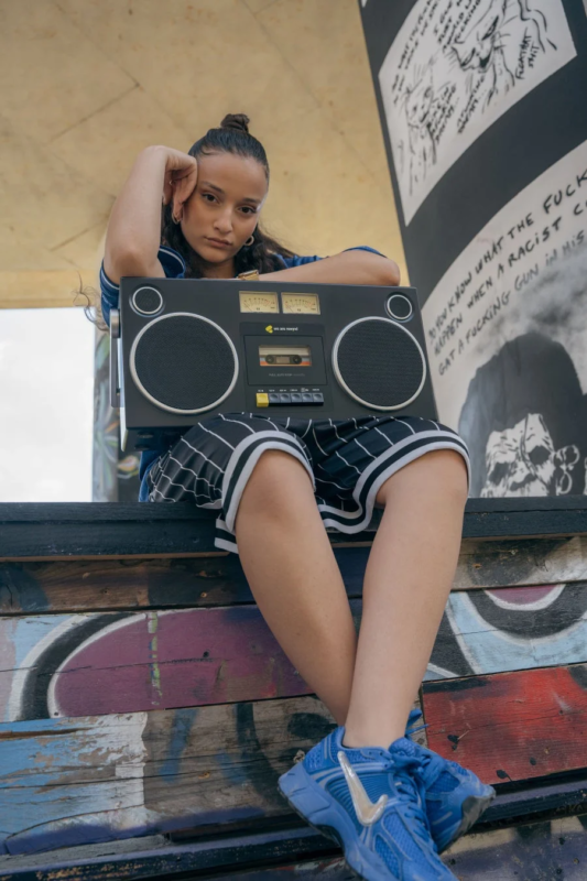 Woman leaning on boombox