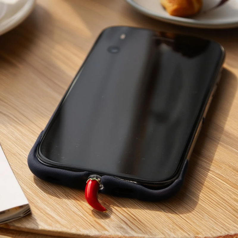 Smartphone with a red chili-shaped charm